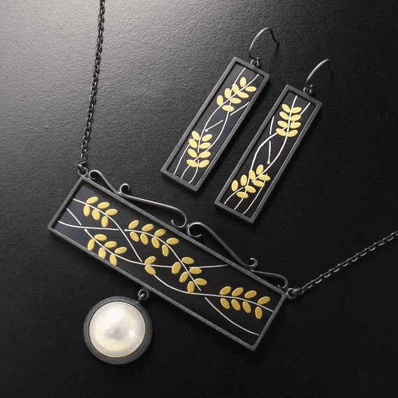 Image Showcasing Shakudo Technique Jewelry Pieces