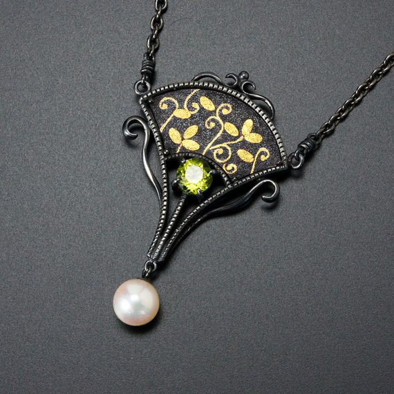 Image Showcasing Shakudo Technique Jewelry Piece