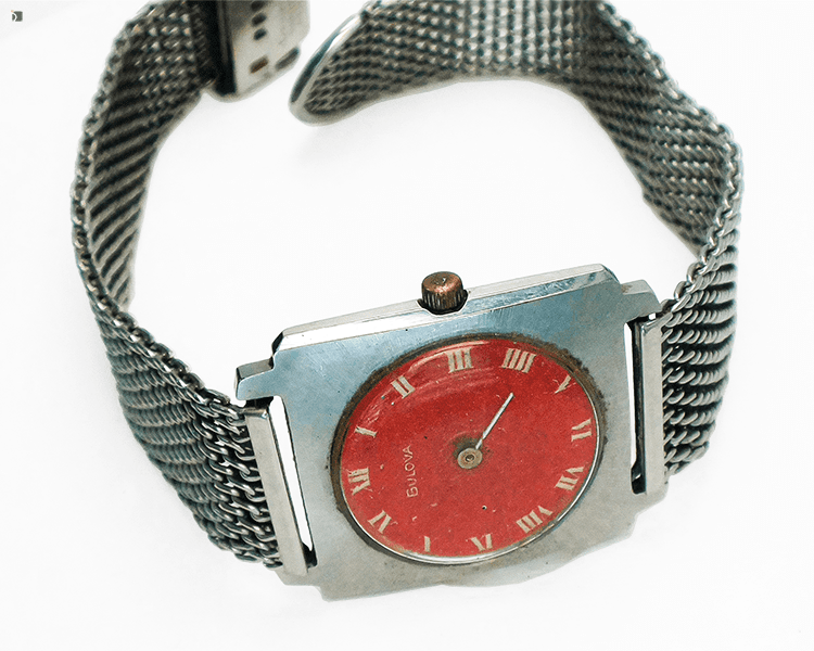 Before #144 Front View of Vintage Bulova Watch Timepiece Laying on Side Prior to Repair