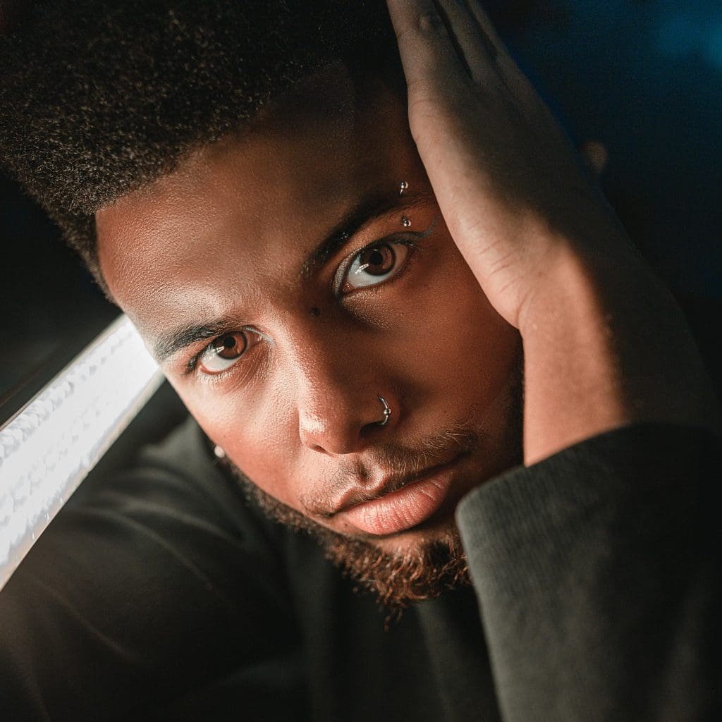 Image of man wearing eyebrow and nose piercings