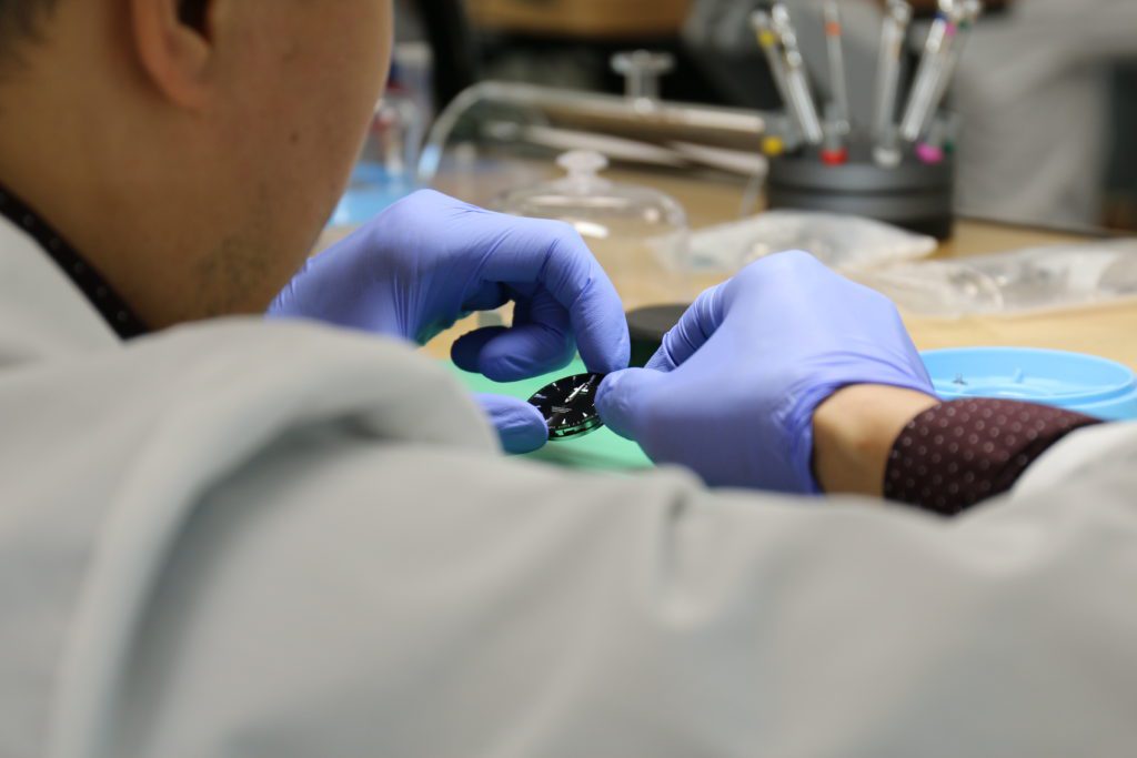 Photo showcasing My Jewelry Repair watchmaker working on repairing watch dial