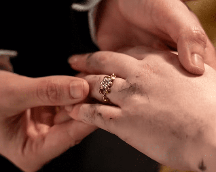 Close Up of Penelope Featherington's Hand with Engagement Ring Held by Colin Bridgerton