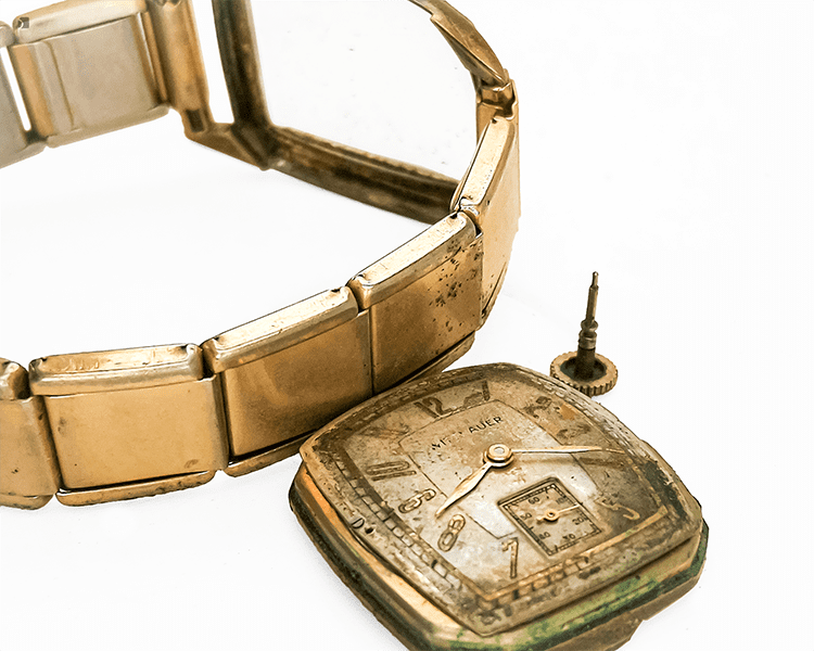 Before #172 Close up of broken down vintage Wittnauer watch, focusing on separate movement and dial