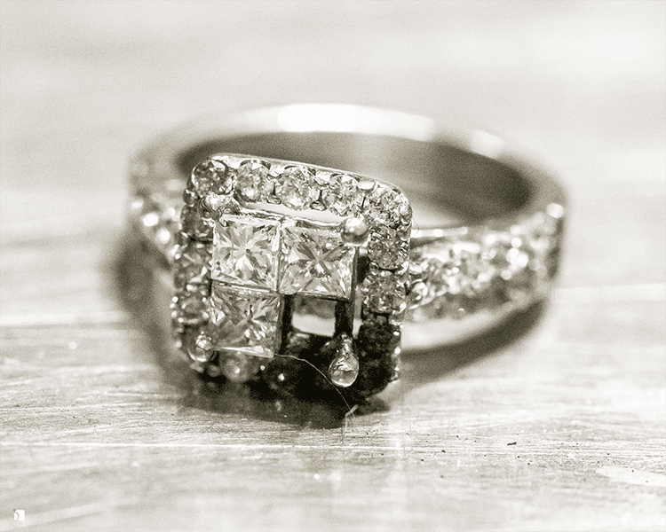 Close Up of Fine Jewelry Invisible Setting Diamond Prior to Professional Restoration Services